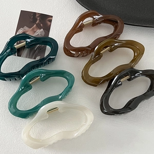 Set of six large wavy hair claws in assorted glossy colors with elegant metal springs