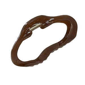 Irregular dark brown hair claw clip with glossy finish and strong metal spring