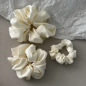 Three-piece set of cream satin scrunchies in various sizes for stylish hair styling