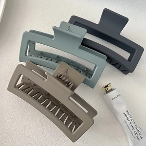 Three oversized matte rectangular hair claws in grey, blue and brown for thick hair