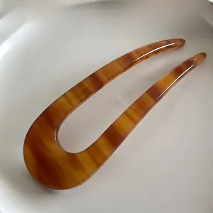 Detail of amber tortoiseshell U-shaped hair pin with France Hand Made gold lettering
