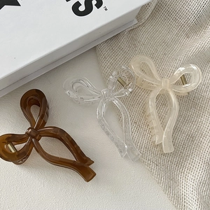 Three-piece ribbon bow hair claws set in dark brown, clear, and cream beige colors