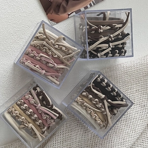 Braided seamless hair ties set in clear boxes with assorted neutral beige and pink colors