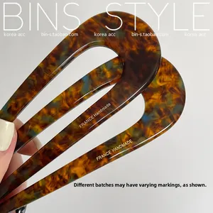 Detailed macro view of tortoiseshell U-shaped hair pin with France Handmade engraving