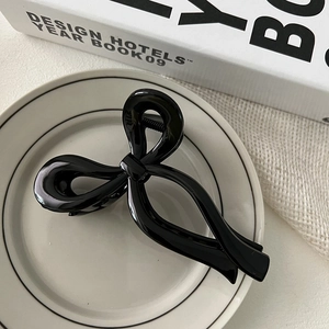 Minimalist black ribbon bow hair claw clip on white decorative plate for women