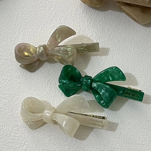 Detail showing the France Handmade engraving on acetate bow hair clips in various colors