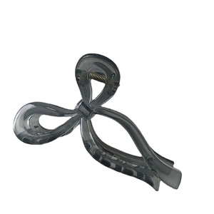Minimalist dark gray translucent bow shark hair claw clip with cutout ribbon design