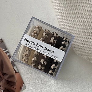 Set of 8 premium elastic hair ties in earthy tones neatly stored in an acrylic box