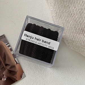 Close-up of 8-piece braided hair tie set in a clear box with strong elastic feature