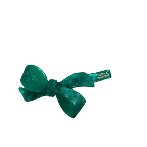 Handmade green acetate bow hair clip with vintage marble texture for elegant side styling