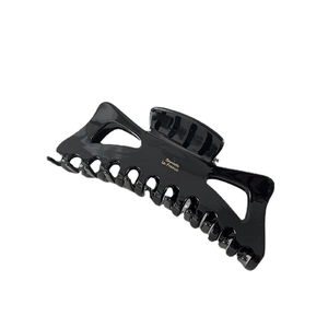 Large black hollow bow claw clip with gold Barrette la France lettering on white background