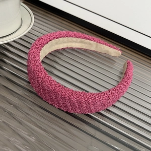 Macro view of wide rose pink headband with shiny metallic thread and plush texture