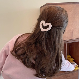 Luvmood irregular hollow heart hair clip in cream pink matte finish worn by a model