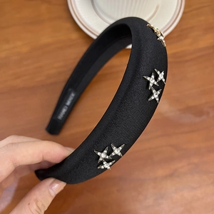 Detail of black velvet headband with sparkling silver rhinestone star embellishments