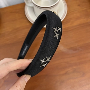 Detail of black velvet headband with sparkling silver rhinestone star embellishments