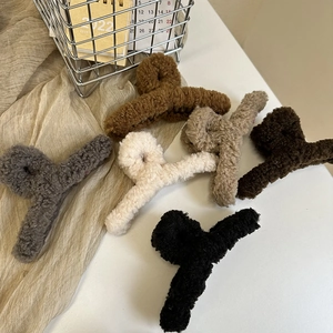 Detailed view of plush shark hair clips in six autumn colors with soft faux fur texture