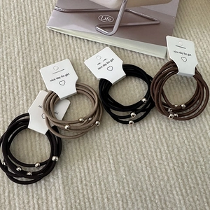 Set of 5 elastic hair ties with metallic beads in black and brown neutral tones