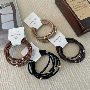5-pack elastic hair ties with gold beads in neutral tones on white display card