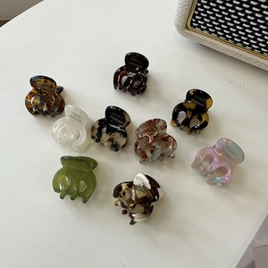 Set of 9 multi-color acetate mini hair claws for women featuring a handmade French style design