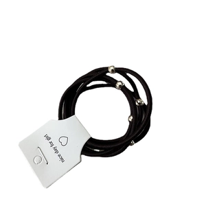 Five-pack of black elastic hair ties with polished silver metal beads on white card
