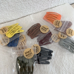 Detail of matte finish colorful snap hair clips in handmade packaging for women