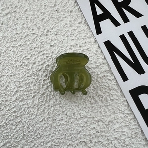 Detailed macro view of olive green acetate hair claw with France Handmade inscription