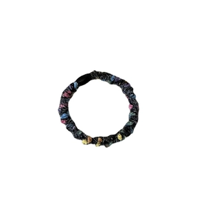 Colorful speckled black plush hair scrunchie with soft knitted texture and high elasticity