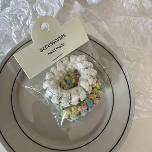 Detail of colorful fuzzy scrunchies and white faux fur hair ties in minimal packaging