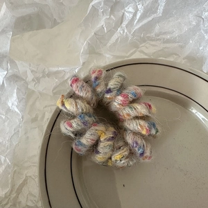 Gros plan d'élastiques spirales en peluche colorée avec texture laineuse en bol