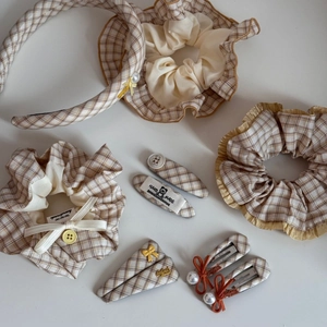 Yellow and beige plaid hair accessory set with headband, scrunchies, and pearl clips