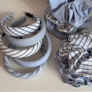 Close-up of light blue and white checkered fabric headbands and large scrunchies set