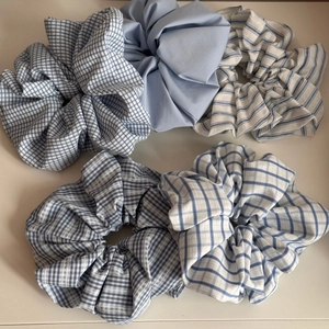 Detail of blue and white plaid fabric scrunchies with soft cotton texture for hair