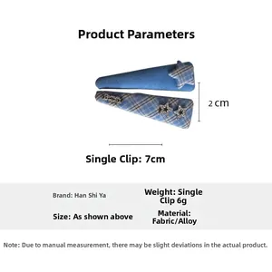 Detail of blue plaid hair clips with 3D star element and polished fabric finish