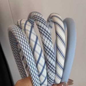 Detail showing a set of 5 blue and white plaid fabric headbands with sponge padding