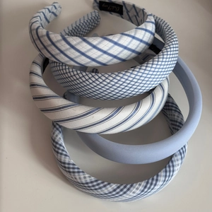 Detail showing blue and white plaid fabric headbands set with striped patterns