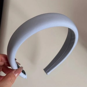 Close-up of light blue thick padded headband with vintage fabric texture and non-slip lining
