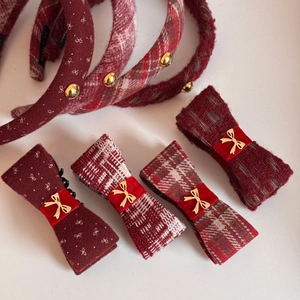 Elegant red tweed and velvet bow hair clip set with gold accents on white background