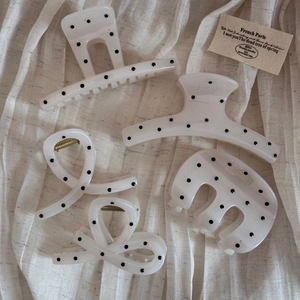 Polka dot hair claw set with 5 different shapes on a beige linen background