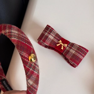 Detailed macro view of the handmade tweed fabric texture and golden butterfly charm