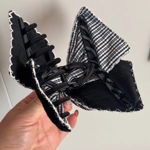Detail of large butterfly hair claw with black lace and white wavy stitched edges