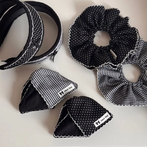 Detailed set of black and white polka dot and plaid lace hair accessories with wavy edges