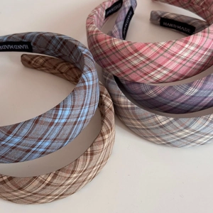 Close-up of handmade plaid wide headbands in various colors with high crown design