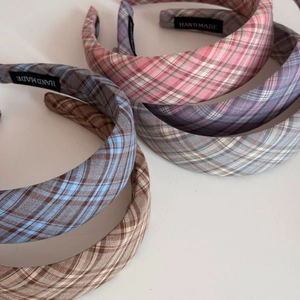 Wide plaid fabric headbands in various colors featuring handmade woven label