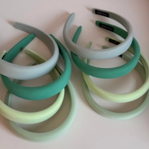 Collection of thick sponge headbands in various shades of Morandi green with matte fabric