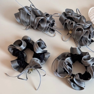 Elegant ruffled scrunchies set with ribbons and charms for low ponytail hairstyles