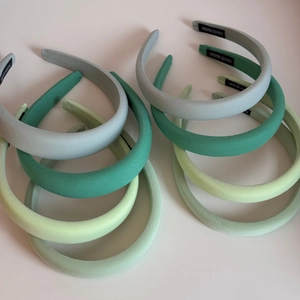 Macro shot of Morandi green sponge headbands showing matte texture and hand made label