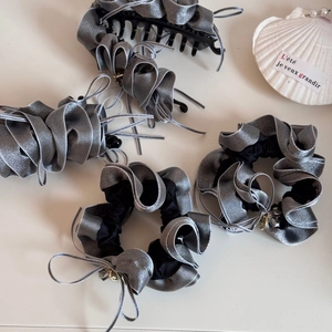 Silver ruffled scrunchies and hair clips set with shimmering metallic finish fabric