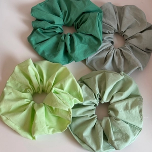 Detailed set of four green cotton scrunchies in mint and sage shades for women