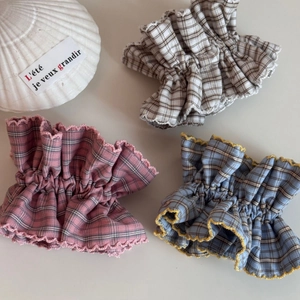 Detailed view of pink blue and brown plaid ruffle hair ties with delicate wavy edge trim