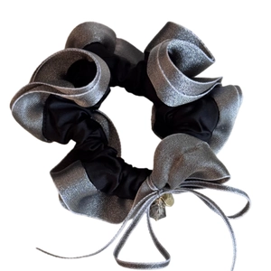 Elegant black scrunchie with silver ruffle trim and crystal bow pendant for hair